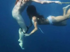 LovelyClips presents: Bikini girls swim in the ocean and strip