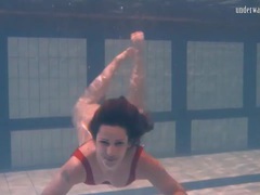 LovelyClips presents: Swimming brunette in one piece swimsuit