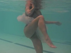 LovelyClips presents: Sheer white dress on a teen swimming in the pool